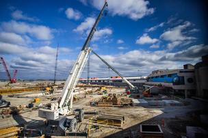 A construction site with a blue cloudy sky above it.