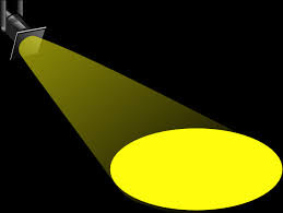 A yellow spotlight in front of a black background.